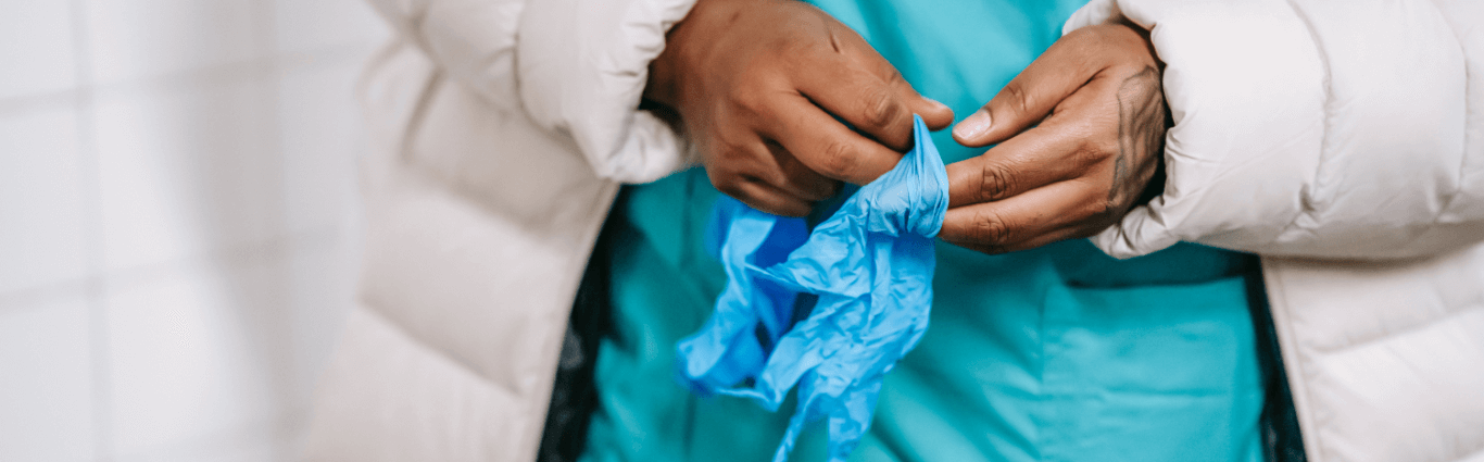 Worker putting on protective gloves
